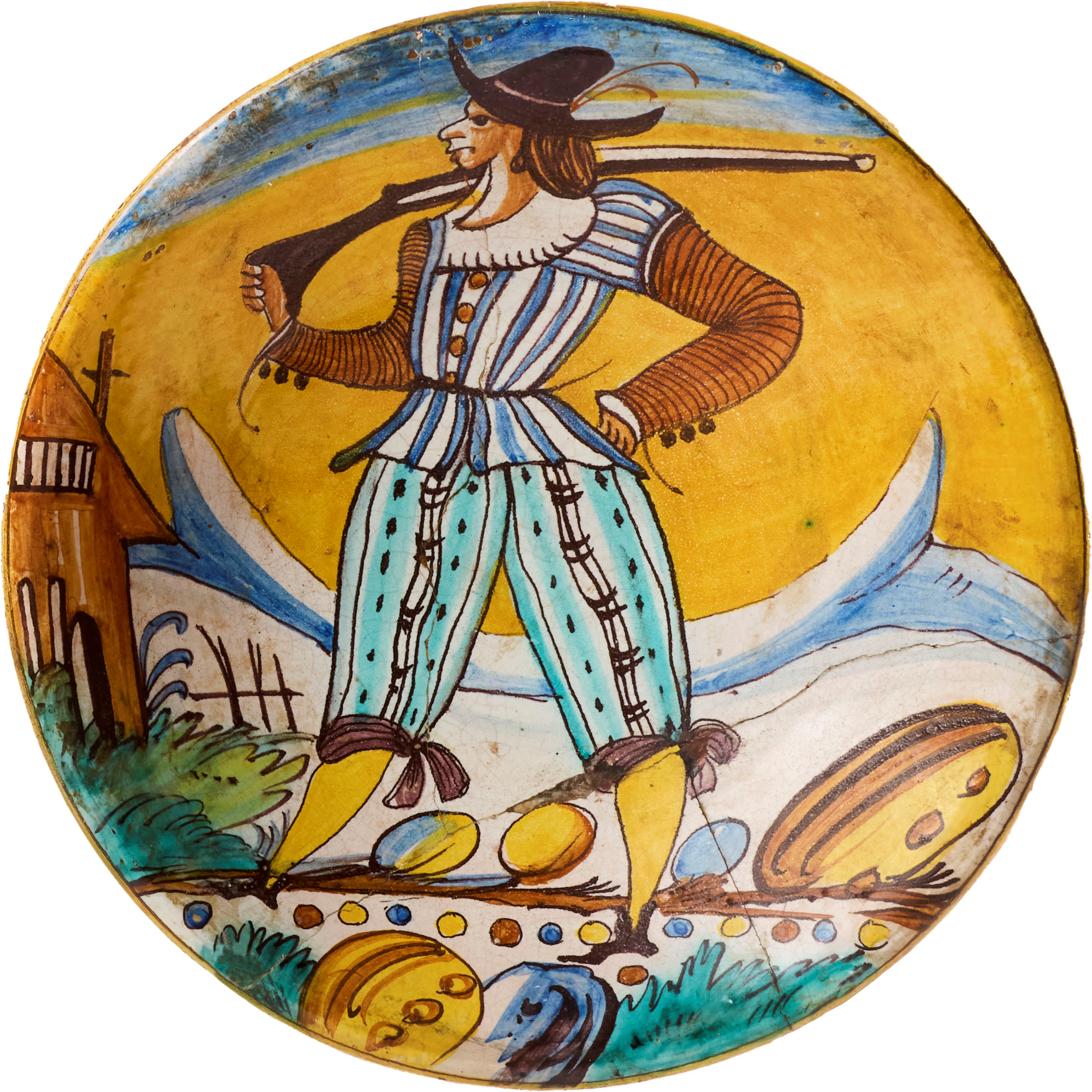 Due piatti in maiolica policroma giallo, blu, verde e ocra