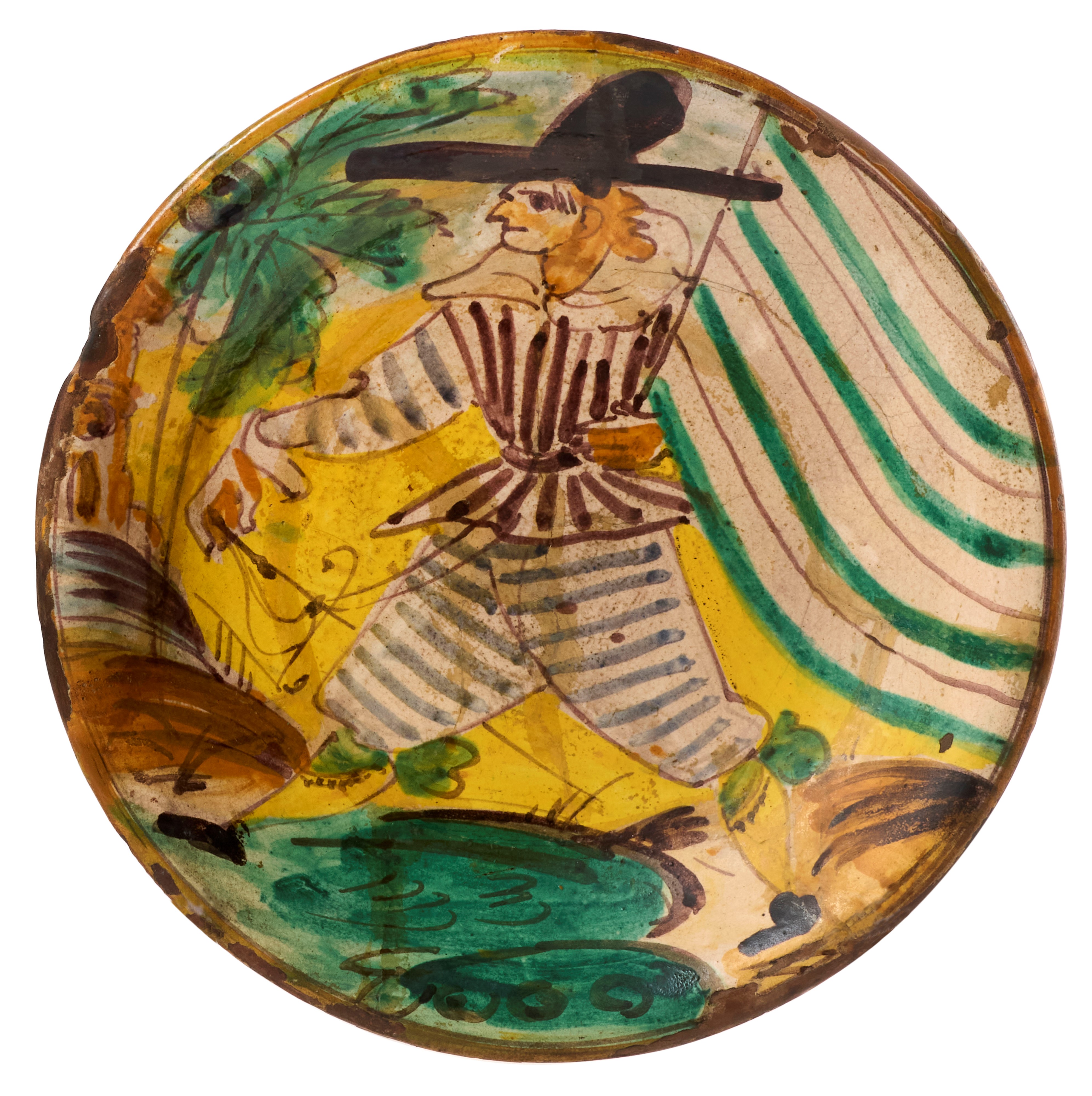 Due piatti in maiolica policroma giallo, verde, blu, ocra e manganese