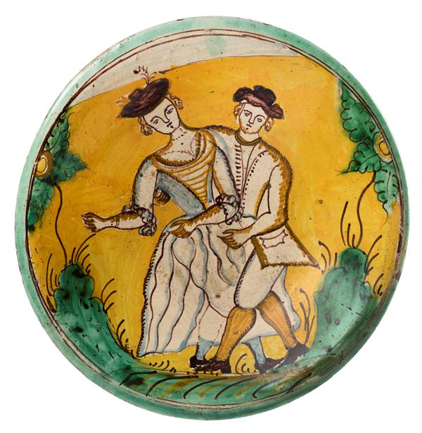 Piatto in maiolica policroma giallo, verde, ocra, azzurro
