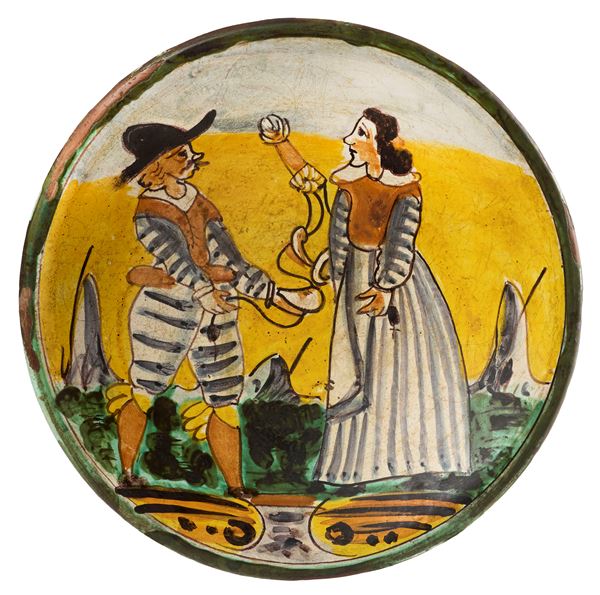Piatto in maiolica policroma giallo, ocra, blu e verde