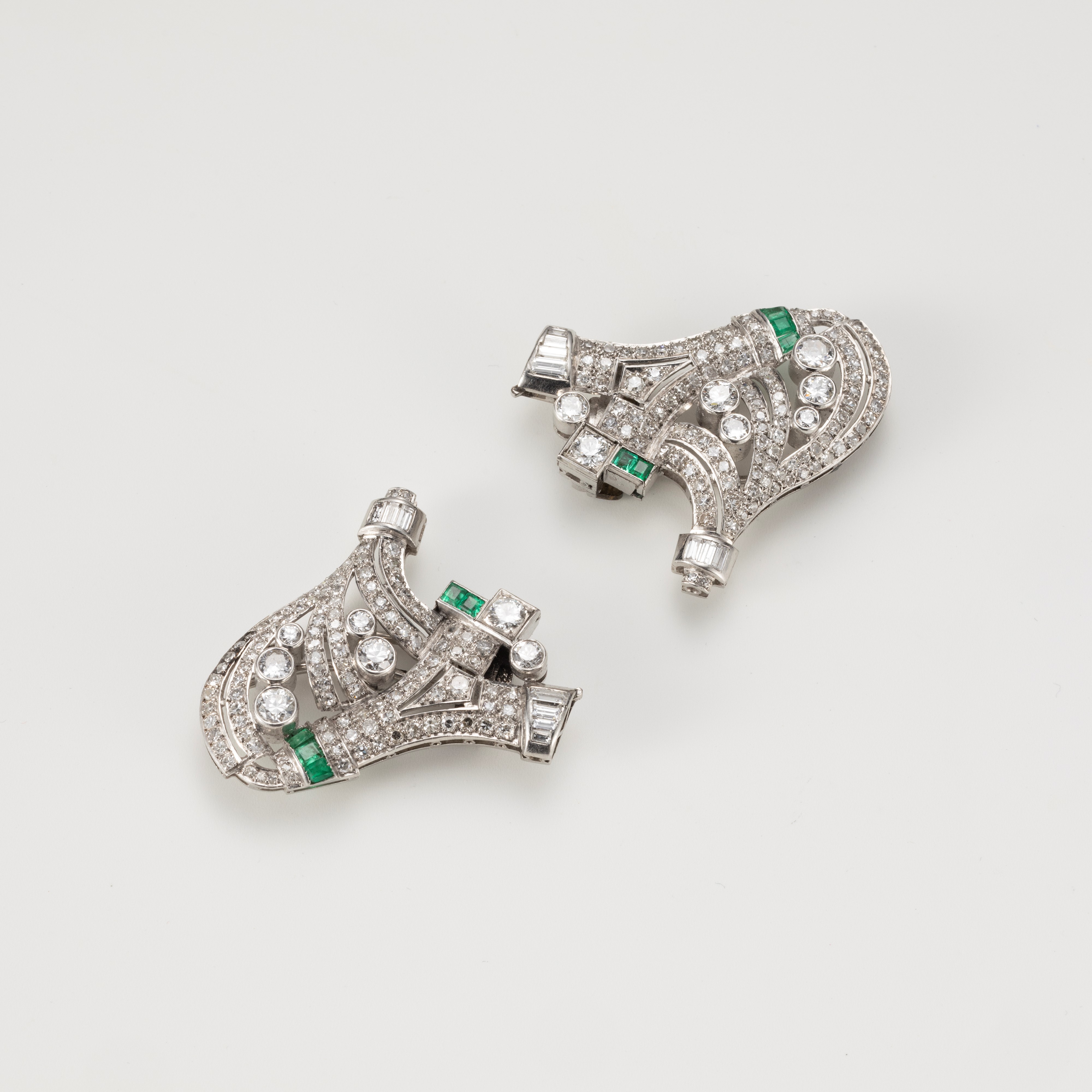 Spilla a doppia clips in oro bianco con diamanti e smeraldi