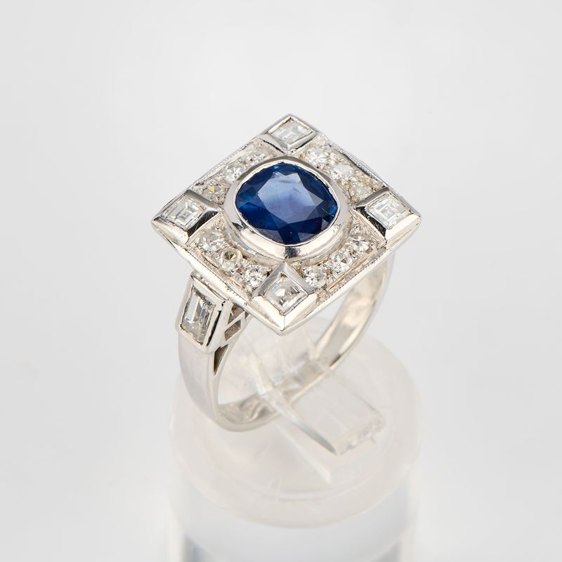 Anello in oro bianco 18 kt con zaffiro centrale e diamanti