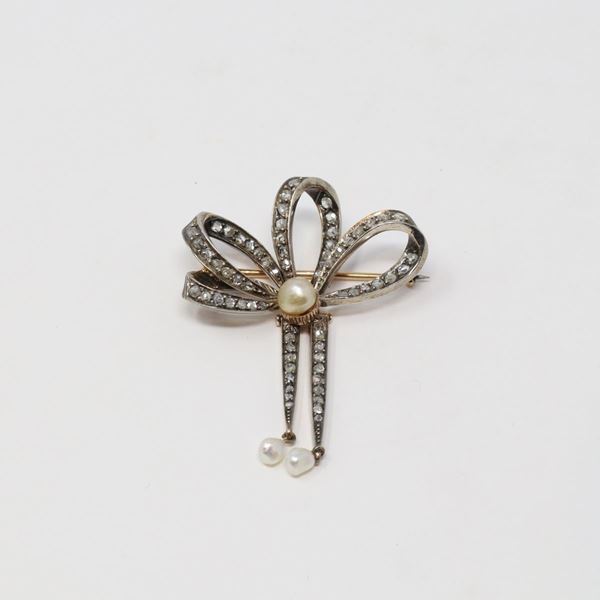 Spilla a forma di fiocco in oro, argento, rose di diamante e perle